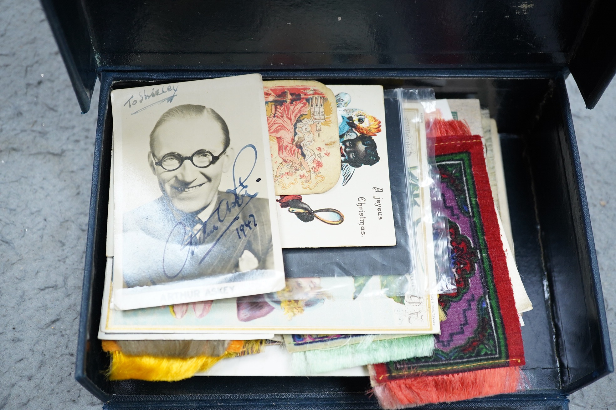 A collection of ephemera including an autographed photograph of Arthur Askey, silk cigarette card, miniature carpets, etc.